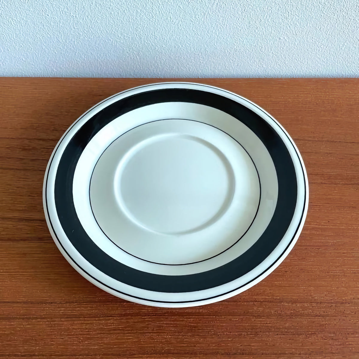 Arabia Finland Faenza Black Tea Cup with Saucer featuring a vintage ceramic saucer with a bold black and white design, showcasing classic Scandinavian craftsmanship.