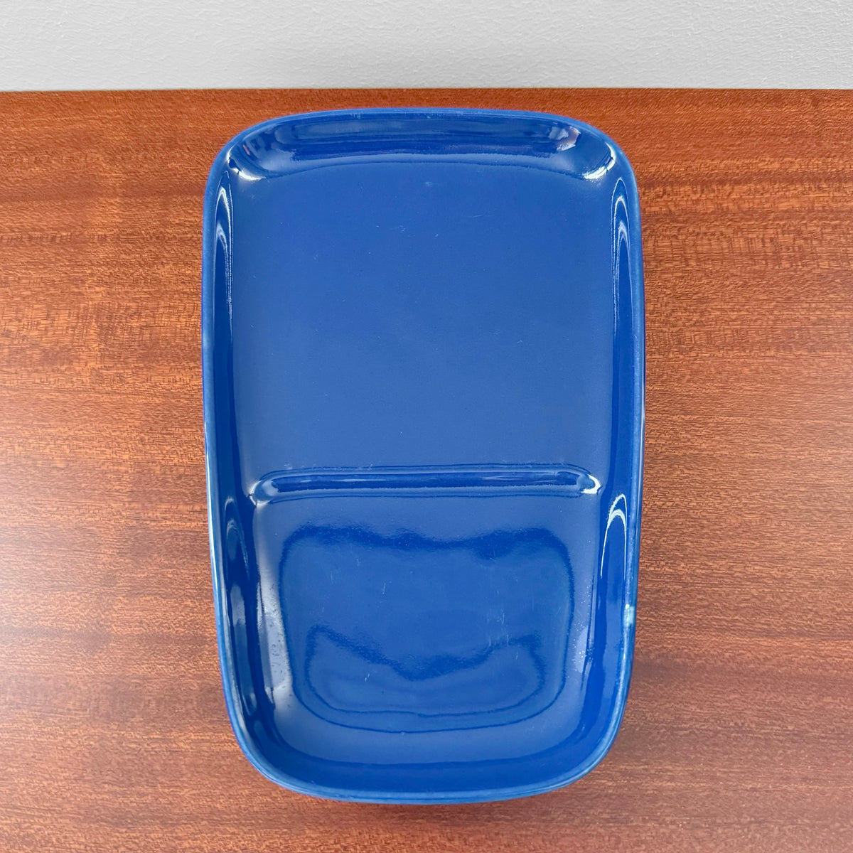 Arabia Finland Kilta Blue TV Set ceramic tray with a deep blue glaze, designed by Kaj Franck, vintage Nordic decorative object displayed on a wooden surface.