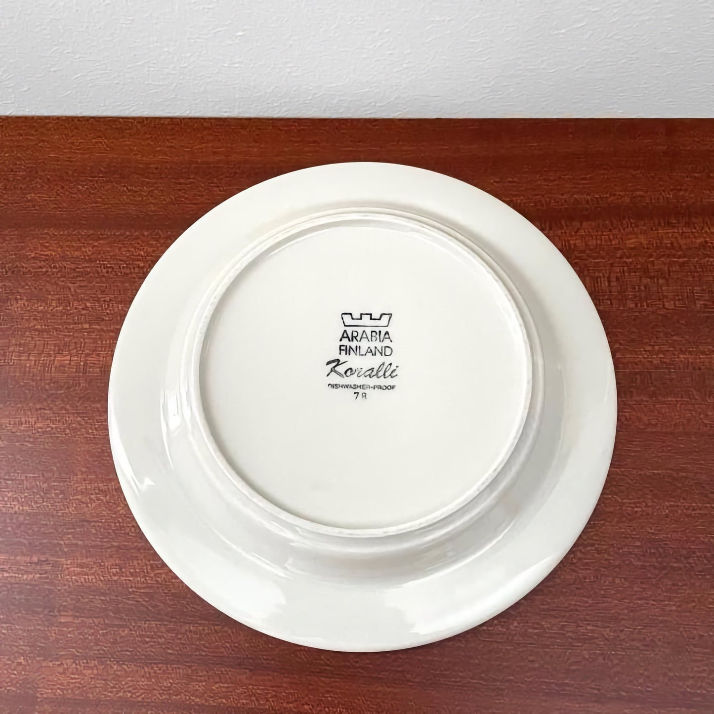 Back of a white ceramic plate from the Arabia Finland Koralli Coffee Cup Trio Set, featuring the official Finland marking and vintage design details.