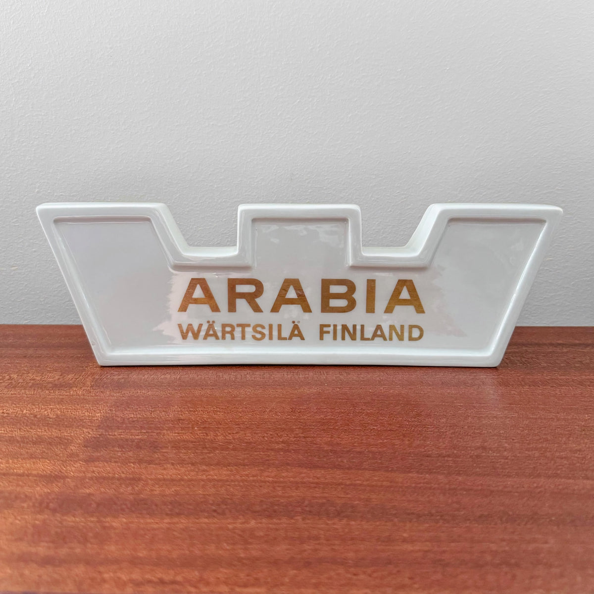 Arabia Wärtsilä Finland Large Dealer Sign in white ceramic with gold lettering, vintage Nordic decorative object showcasing authentic Scandinavian craftsmanship.