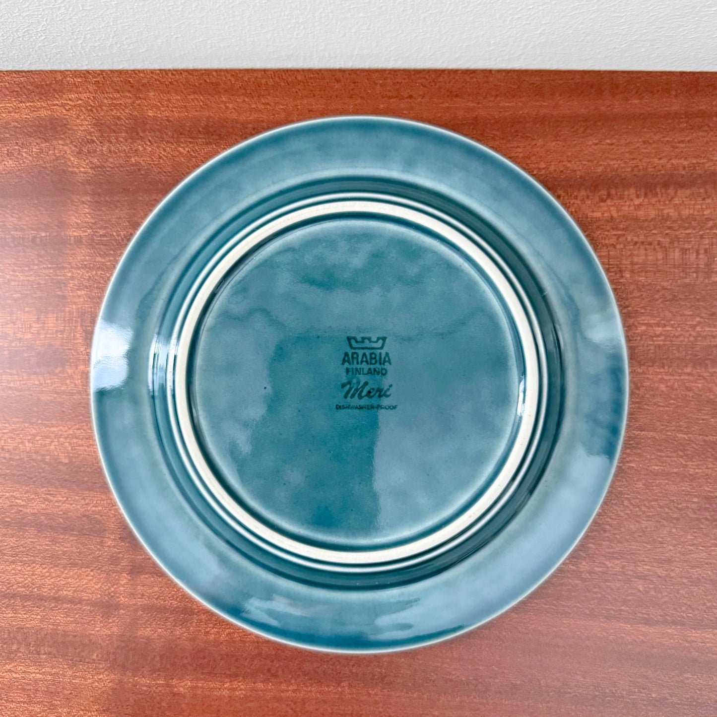 Vintage ceramic cake plate in teal blue with white ring detailing from the Arabia Finland Meri Tea Cup Trio Set, showcasing classic Nordic craftsmanship.