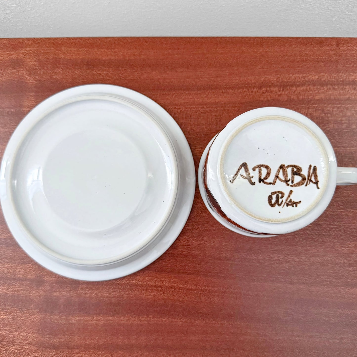 Arabia Finland Rosmarin Tea Cup with Saucer showing the underside markings on white ceramic pieces, highlighting vintage Nordic Scandinavian craftsmanship.