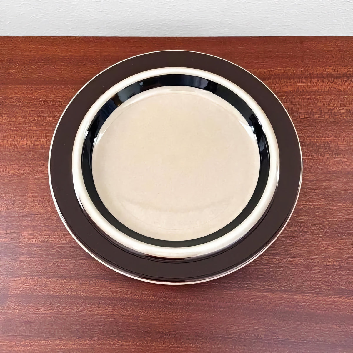 Arabia Finland Ruija Coffee Cup Trio Set cake plate featuring vintage 1970s Scandinavian ceramic design with bold dark brown and cream circular patterns.