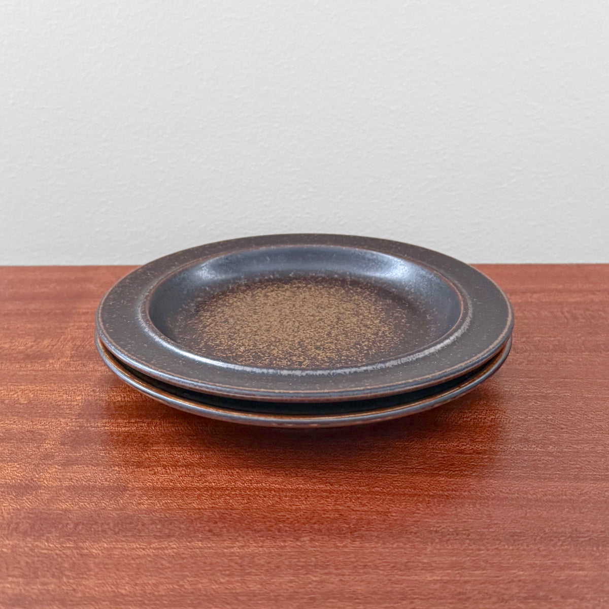 Pair of vintage Arabia Finland Ruska Cake Plates with brown speckled ceramic design, showcasing classic Scandinavian craftsmanship and timeless mid-century style.
