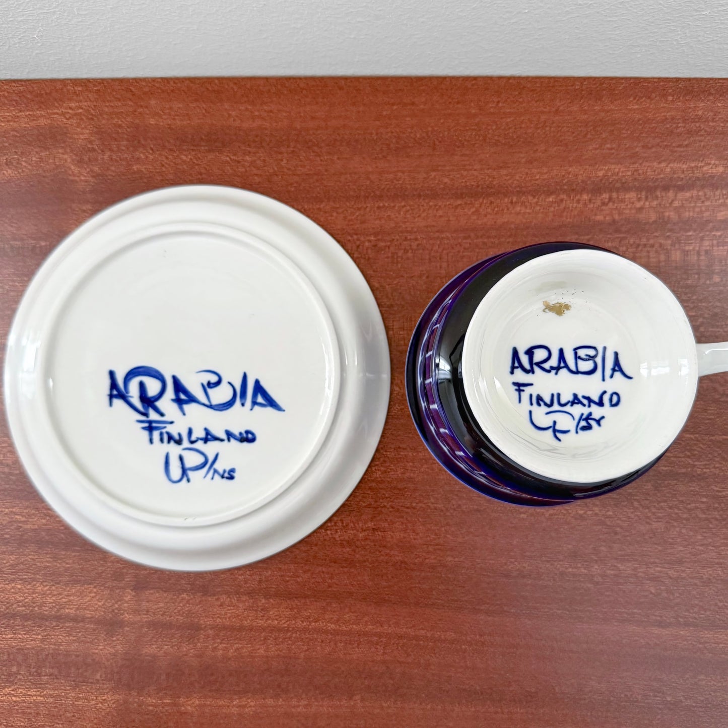 Bottom view of Arabia Finland Valencia Tea Cup with Saucer showing hand-painted signature on ceramic base, highlighting authentic vintage Nordic ceramics craftsmanship.