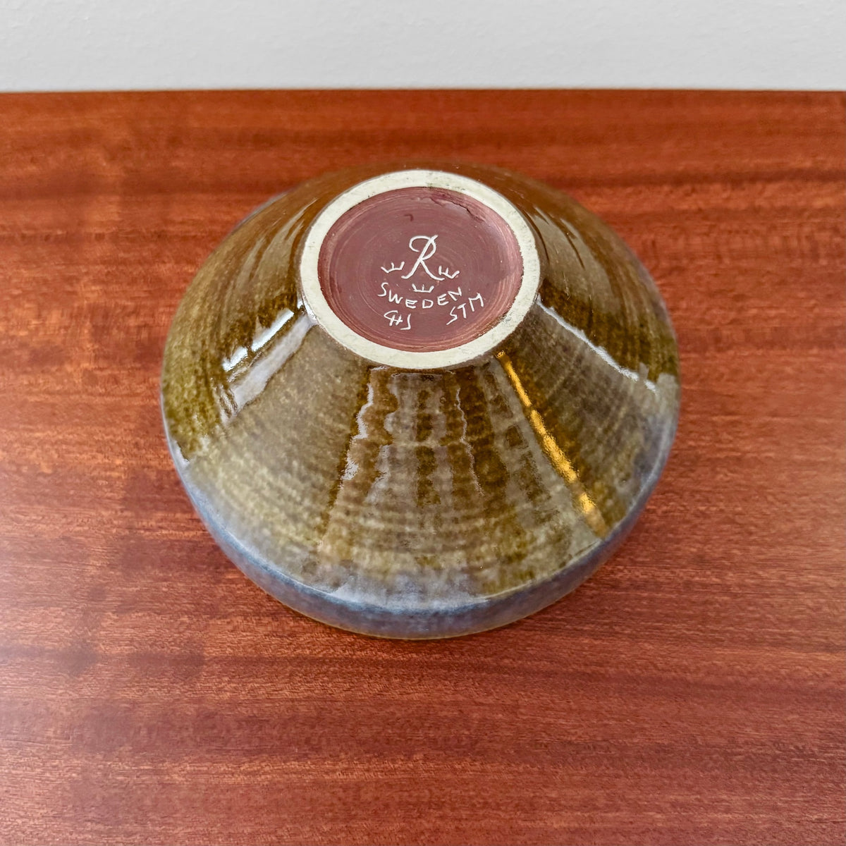 Carl-Harry Stålhane Rörstrand STM Stoneware Decorative Bowl shown upside down, featuring blue and brown glaze with maker’s mark on base, highlighting vintage Nordic ceramic craftsmanship.