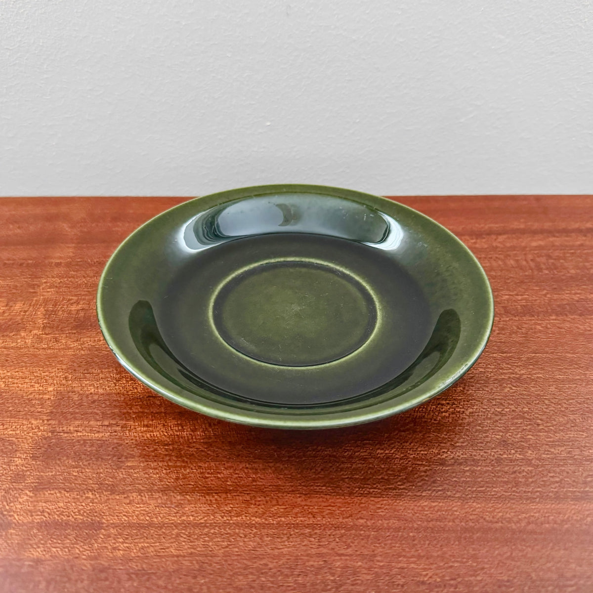 Upsala-Ekeby/Gefle Bladranka Tea Cup with Saucer ceramic saucer in deep green glaze, vintage Scandinavian tableware piece from the 1960s, ideal for Nordic Wares Store collection.