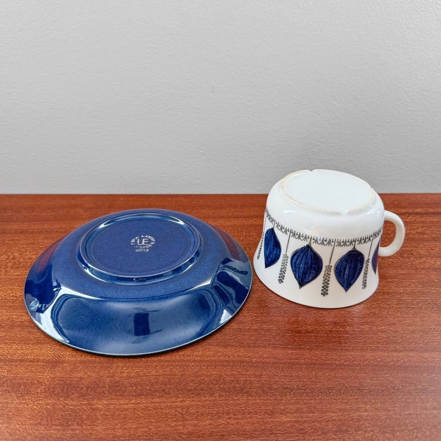 Upsala-Ekeby/Gefle Groblad Blue Tea Cup with Saucer featuring vintage Scandinavian ceramic design with blue leaf patterns on the cup and solid blue on the saucer.