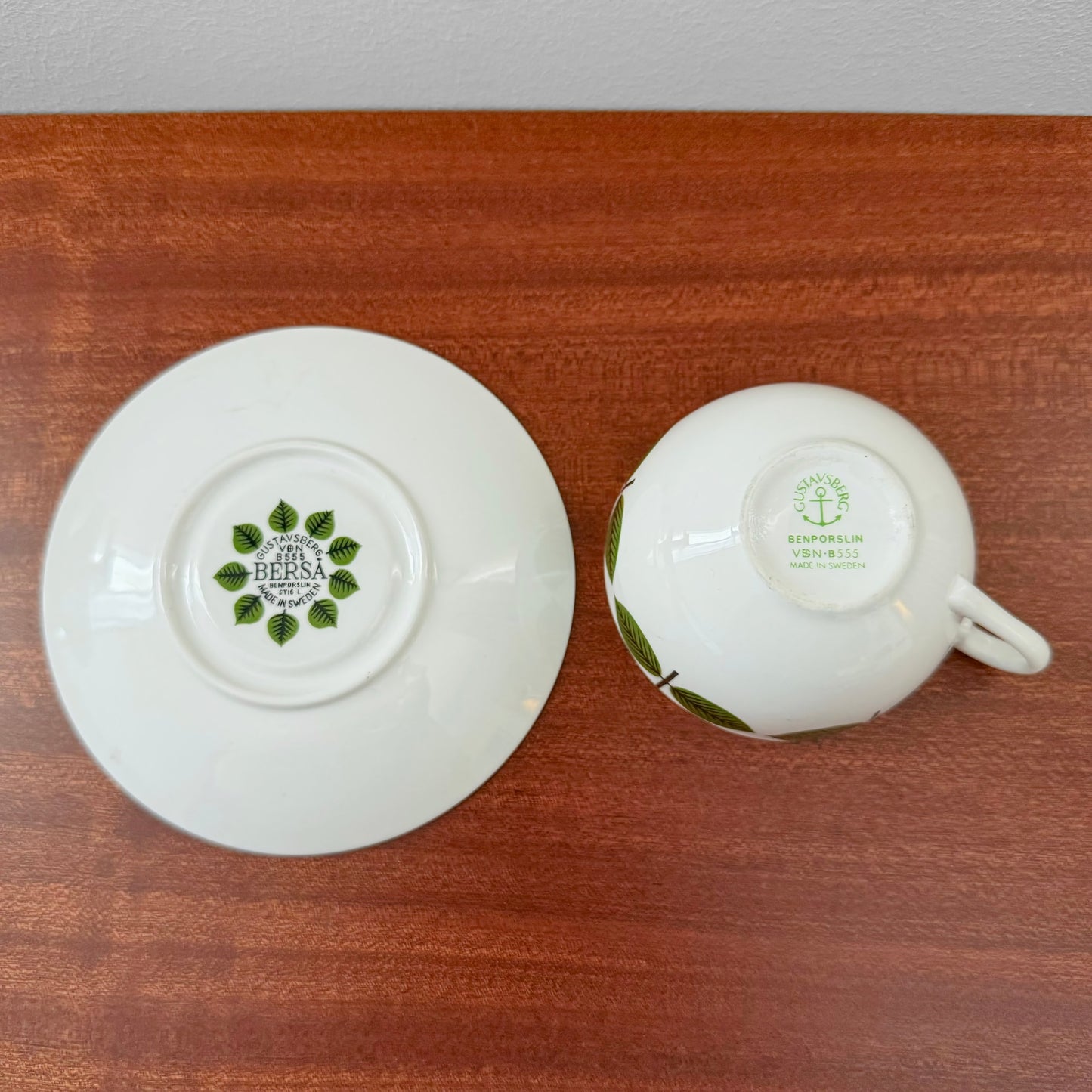 Gustavsberg Berså Coffee Cup with Saucer showing underside details with green leaf pattern markings on white ceramic, highlighting vintage Scandinavian design craftsmanship.