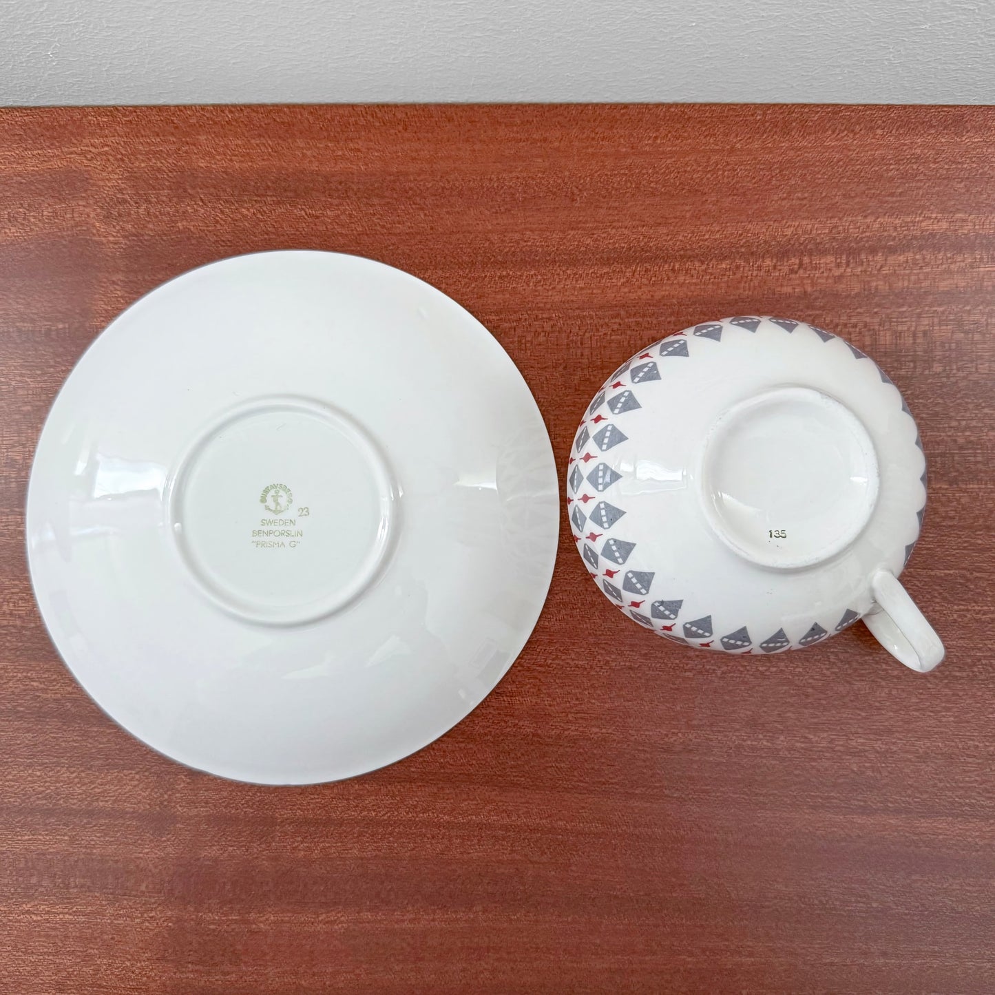 Gustavsberg Prisma Tea Cup with Saucer shown from the bottom, highlighting the vintage Scandinavian ceramic markings and geometric design on the cup.