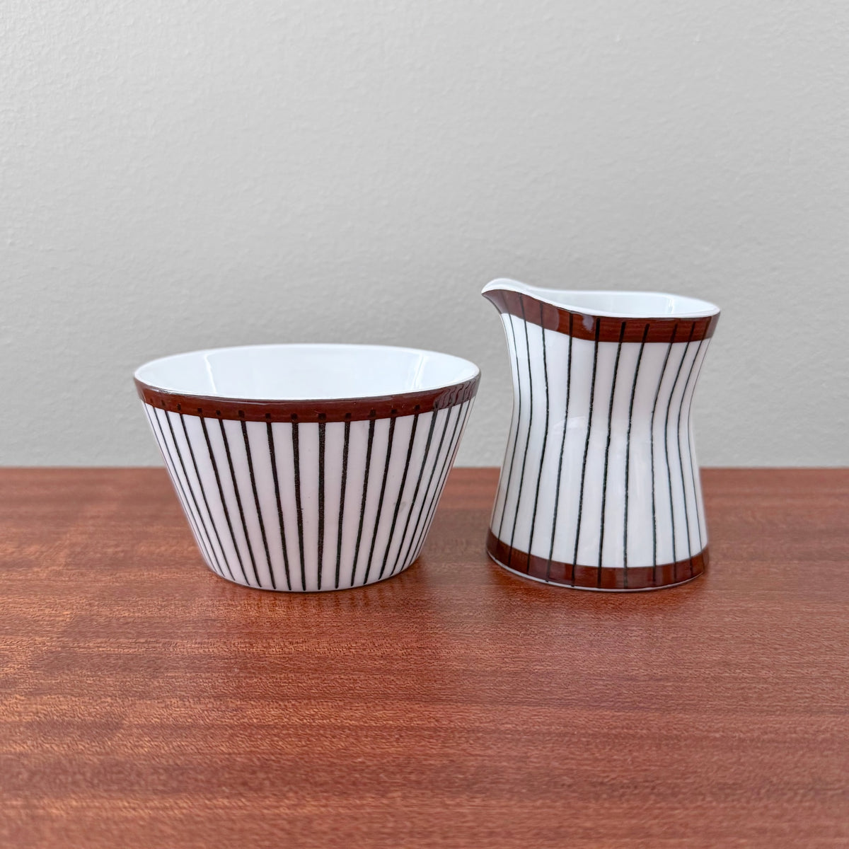 Gustavsberg Spisa Ribb Sugar Bowl and Creamer featuring vertical black ribbed lines and brown trim, designed by Stig Lindberg in a vintage Nordic ceramic style.