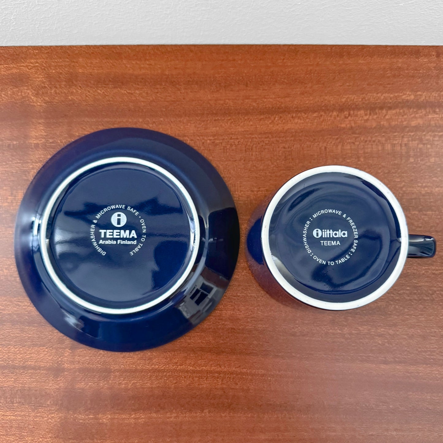 Iittala Teema Blue Tea Cup with Saucer shown from above, featuring deep blue ceramic with white edges, highlighting vintage Nordic design and Kaj Franck's craftsmanship.