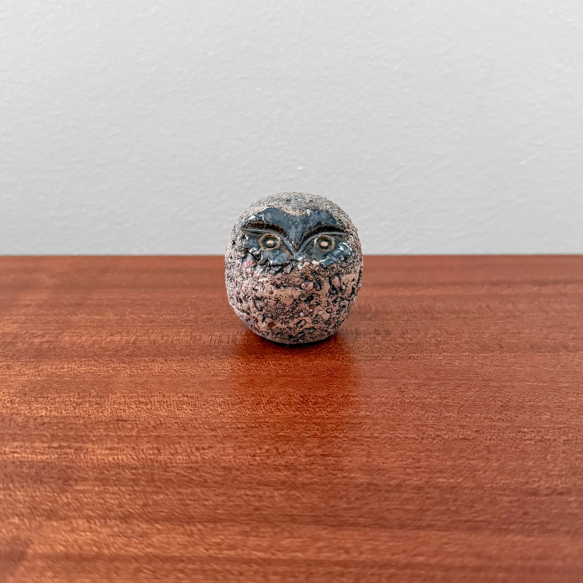 Kaarina Aho Owl Figurine, a vintage ceramic stoneware piece with black glaze face, showcasing Nordic craftsmanship from Finland in the 1960s, placed on a wooden surface.