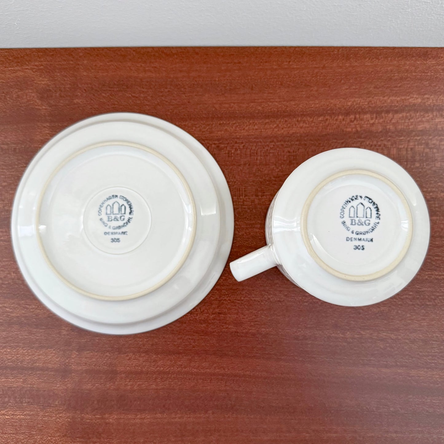 Quistgaard Cordial Palet White Tea Cup with Saucer shown from the bottom, featuring vintage ceramic markings from Bing & Grøndahl, highlighting Nordic craftsmanship.