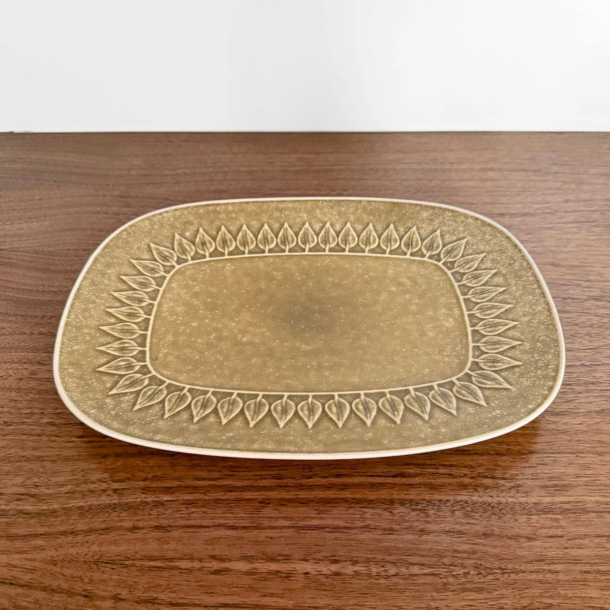 Quistgaard Relief Platter in muted beige ceramic with embossed leaf pattern border, vintage Nordic design ideal for serving cheese and charcuterie.