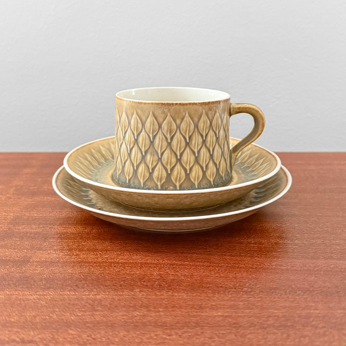 Quistgaard Relief Tea Cup Trio Set featuring a vintage brown ceramic cup with matching saucer and cake plate, showcasing Nordic Scandinavian design and craftsmanship.