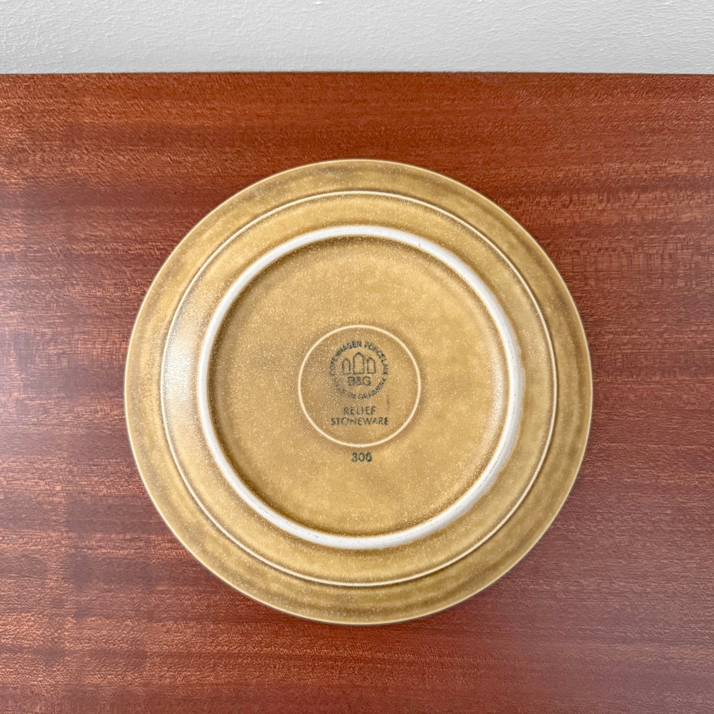 Quistgaard Relief Tea Cup Trio Set ceramic cake plate with textured brown glaze and subtle circular pattern, showcasing vintage Scandinavian design craftsmanship.