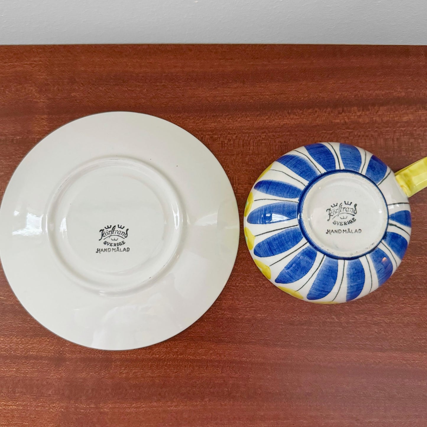 Rörstrand Hand-painted Tea Cup with Saucer showing the underside with vintage maker’s marks, featuring blue and yellow hand-painted Scandinavian ceramic design.