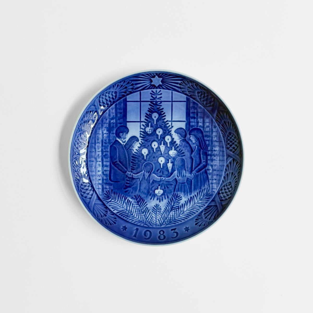 Royal Copenhagen Christmas Plates blue decorative dish with a festive Christmas tree scene and 1983 date, crafted in classic Nordic ceramic style