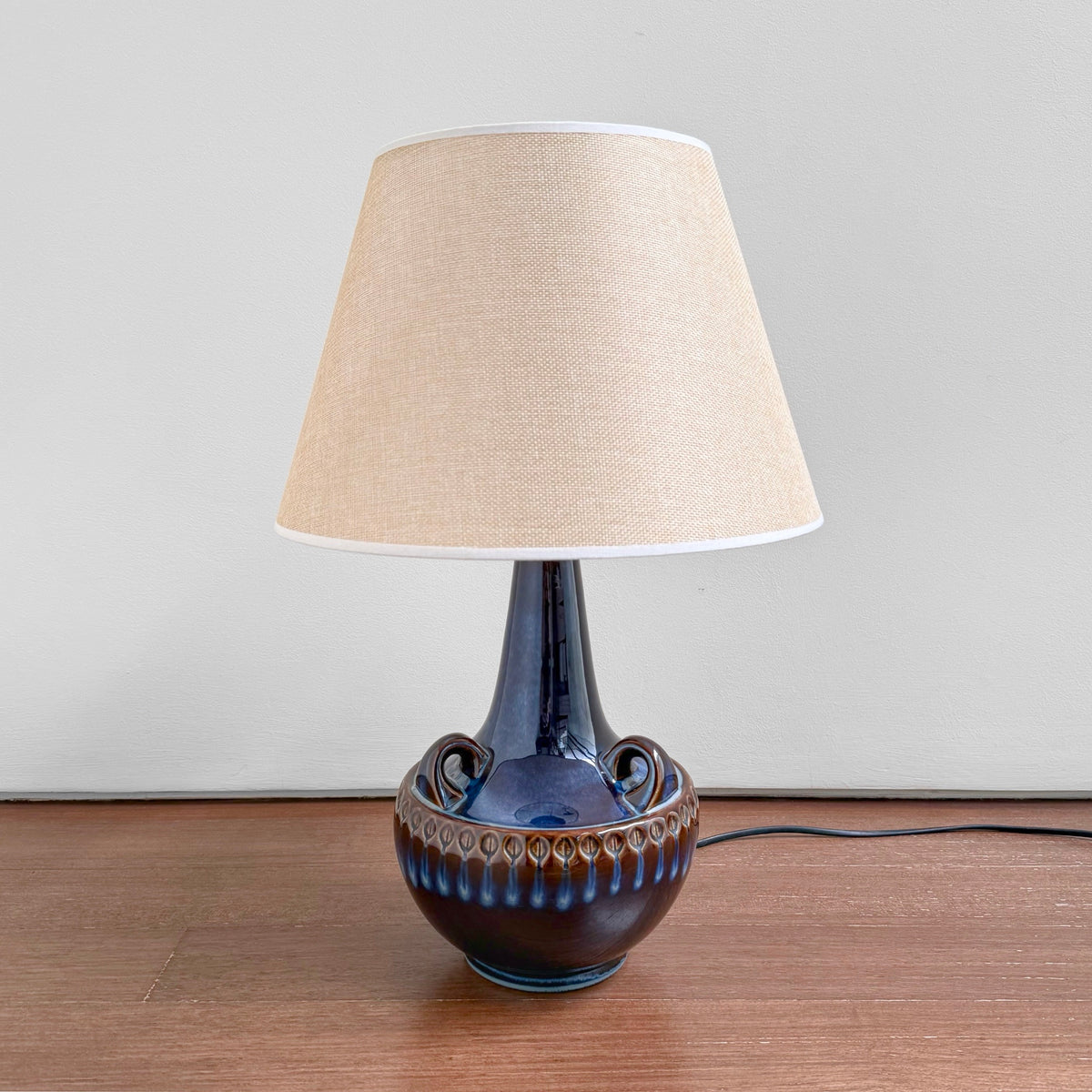 Søholm 1059 Blue Stoneware Table Lamp with blue ceramic base featuring vintage Nordic design and a beige fabric shade, suitable for home decor and lighting.
