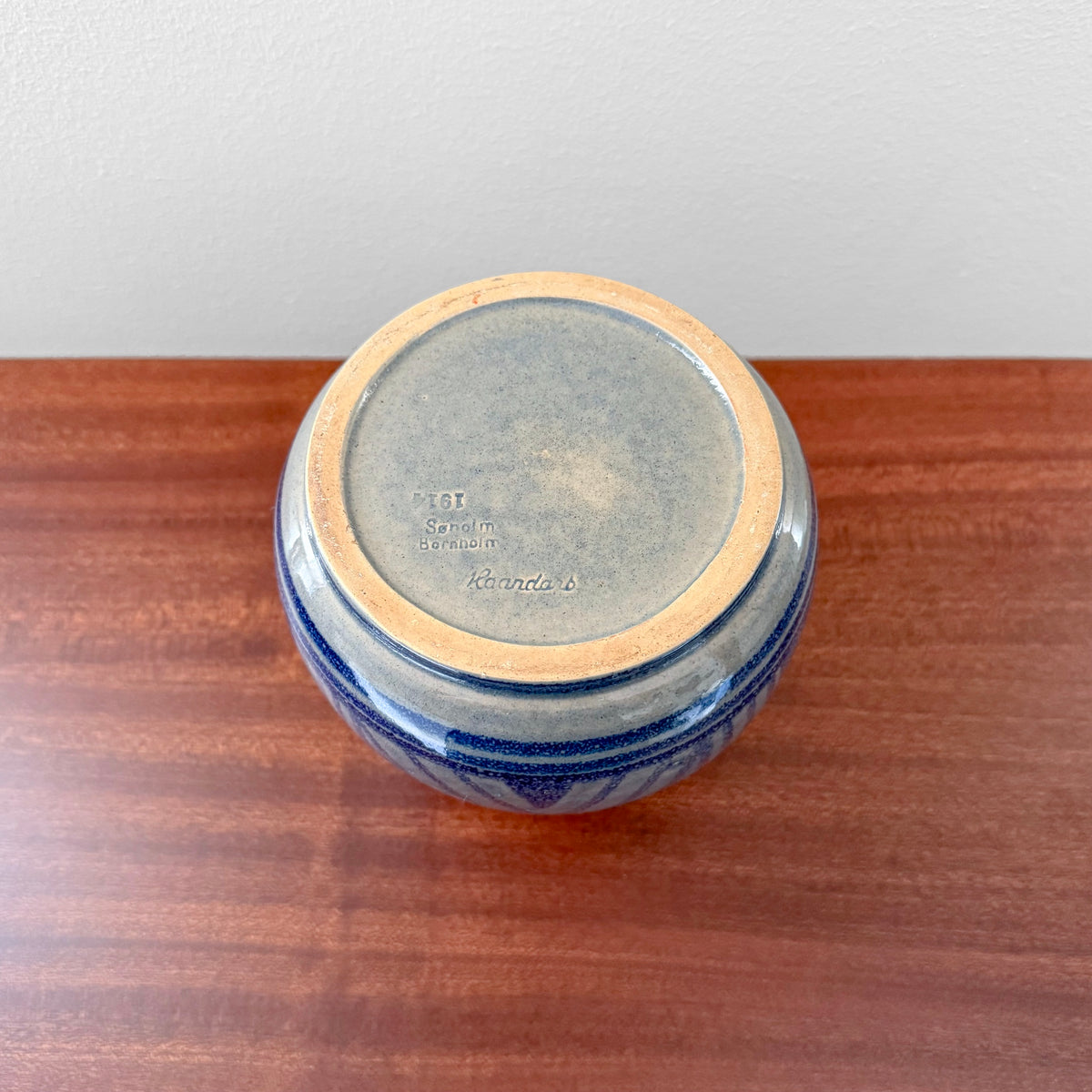 Søholm 1914 Blue Stoneware Vase viewed from below, showing blue ceramic glaze, impressed maker's stamp, and natural crazing on a wooden surface