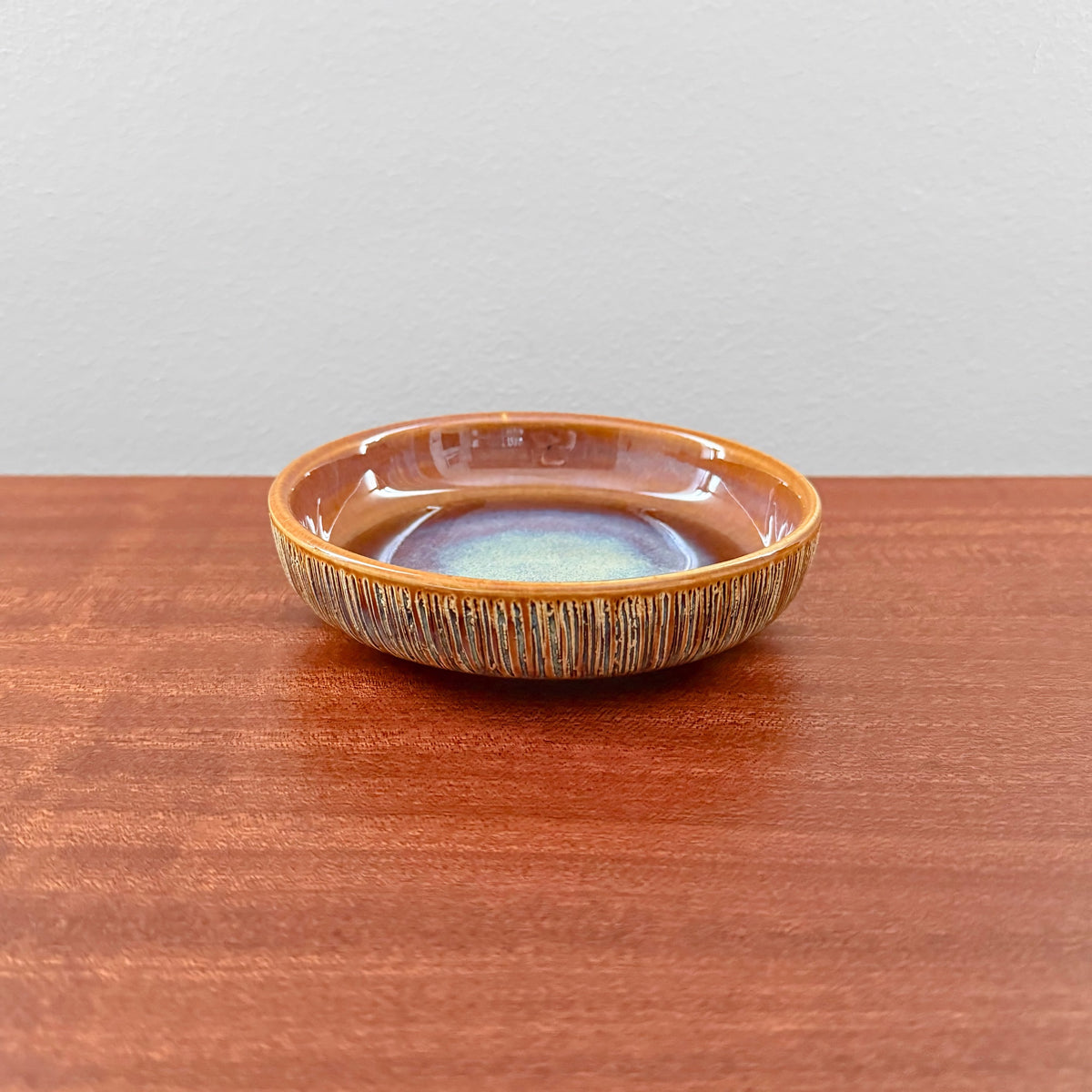 Søholm Manilla Small Stoneware Decorative Dish in warm brown glaze with textured sides and subtle blue-green center, showcasing vintage Nordic ceramics craftsmanship.