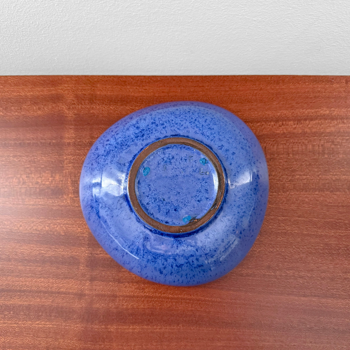 Swedish Blue Decorative Bowl with a rich blue finish and rounded form shown on a wooden surface