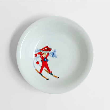 Aina Stenberg Rörstrand Tomtejul Tableware Set deep plate with vintage Nordic skier and Santa illustration in red and blue on white ceramic