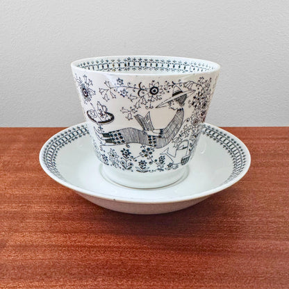 Arabia Finland Emilia Large Cocoa Cup with Saucer featuring black and white vintage illustration of a person reading under a tree, showcasing mid-century Nordic ceramic design.