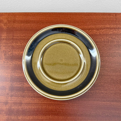 Arabia Finland Kosmos Large Mug with Saucer featuring a vintage ceramic saucer in earthy tones of olive green and black, showcasing authentic Nordic design craftsmanship.