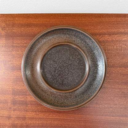 Arabia Finland Ruska Tea Cup with Saucer featuring a vintage ceramic saucer in dark speckled brown glaze, showcasing Nordic craftsmanship and timeless design.