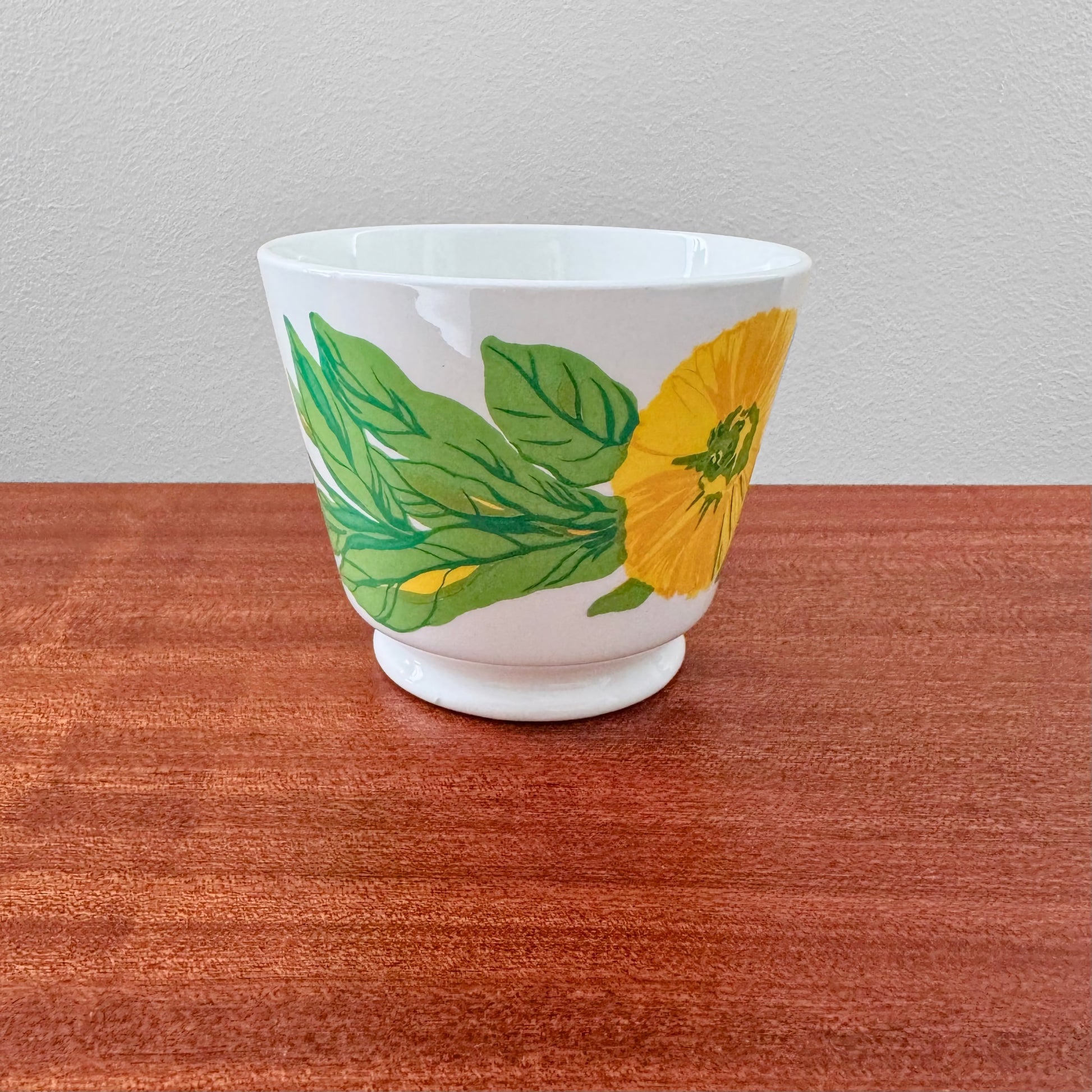 Arabia Finland Suvi Large Cocoa Cup featuring a vibrant yellow flower and green leaves design, showcasing vintage Nordic ceramic drinkware craftsmanship.