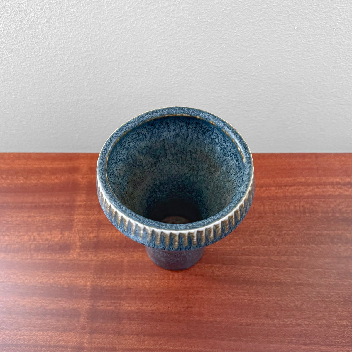 Carl-Harry Stålhane Rörstrand SGZ Stoneware Vase in blue glazed ceramic with a textured fluted rim shown from above on a wooden surface