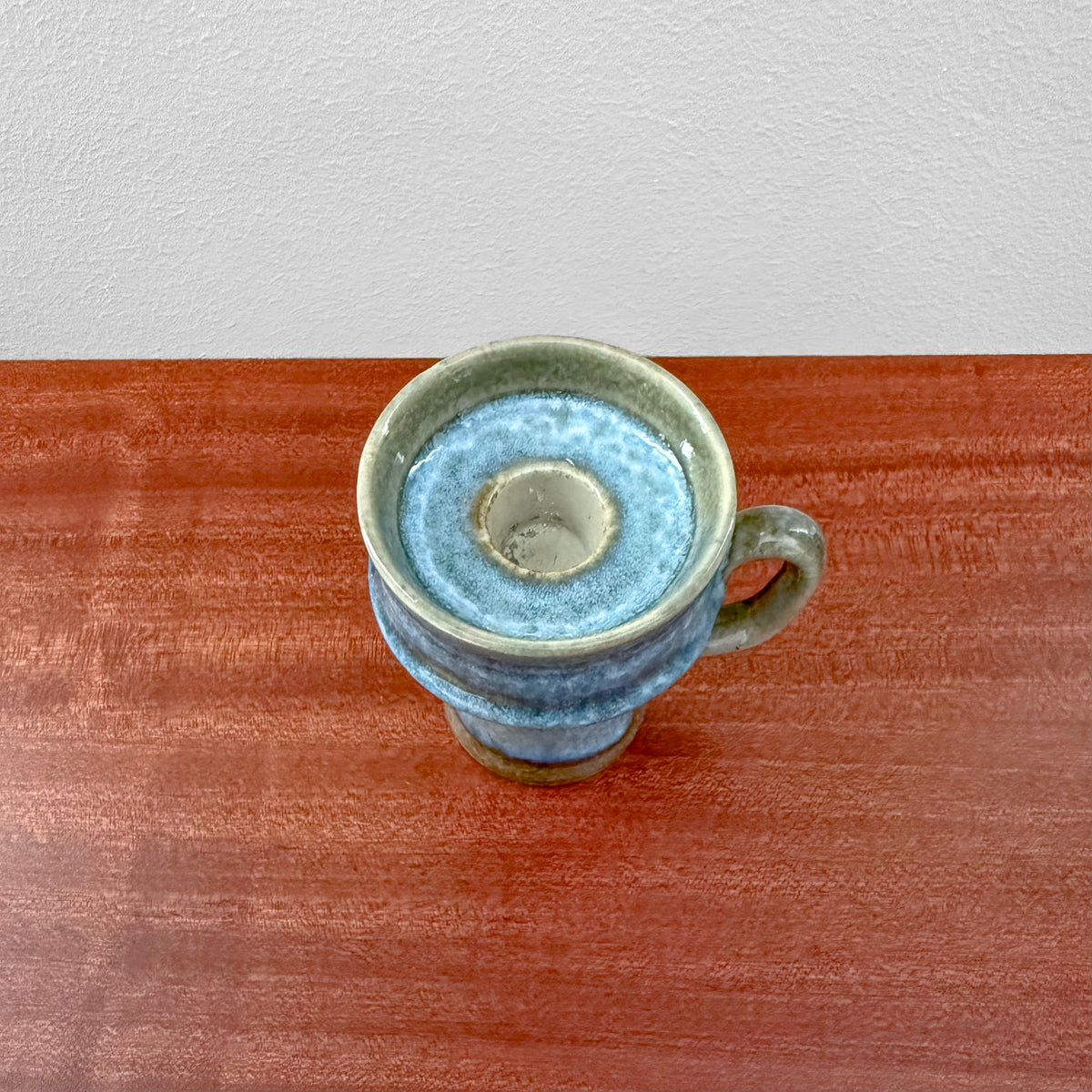 Carl-Harry Stålhane Rörstrand STH Green-Blue Stoneware Candle Holder in green and blue ceramic glaze with handle, displayed on a wooden surface against a plain light background.