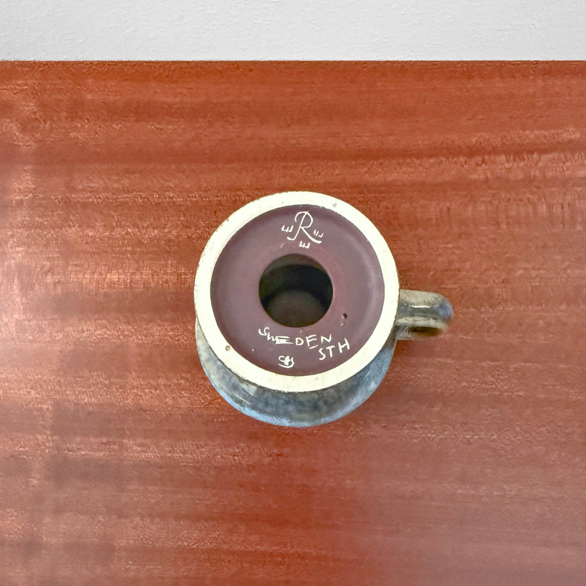 Top view of a Carl-Harry Stålhane Rörstrand STH Green-Blue Stoneware Candle Holder showing the green and blue ceramic glaze with maker’s mark and three crowns symbol on the underside.