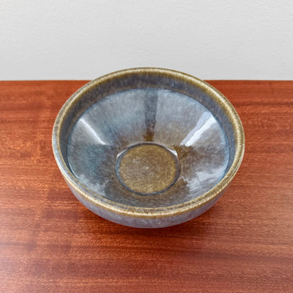 Carl-Harry Stålhane Rörstrand STM Blue-Brown Stoneware Decorative Bowl in blue and brown glaze, showcasing vintage Nordic ceramic craftsmanship on a wooden surface.