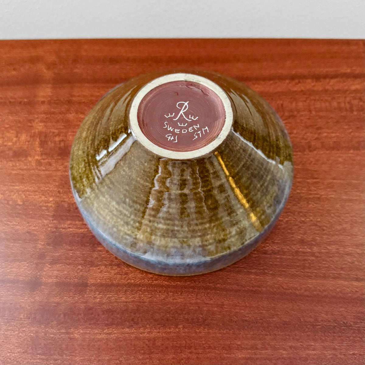 Carl-Harry Stålhane Rörstrand STM Blue-Brown Stoneware Decorative Bowl shown upside down, featuring blue and brown glaze with maker’s mark on base, highlighting vintage Nordic ceramic craftsmanship.