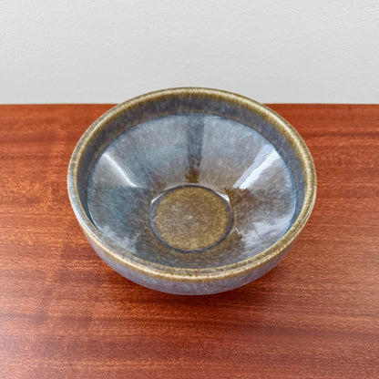 Carl-Harry Stålhane Rörstrand STM Stoneware Decorative Bowl in blue and brown glaze, showcasing vintage Nordic ceramic craftsmanship on a wooden surface.