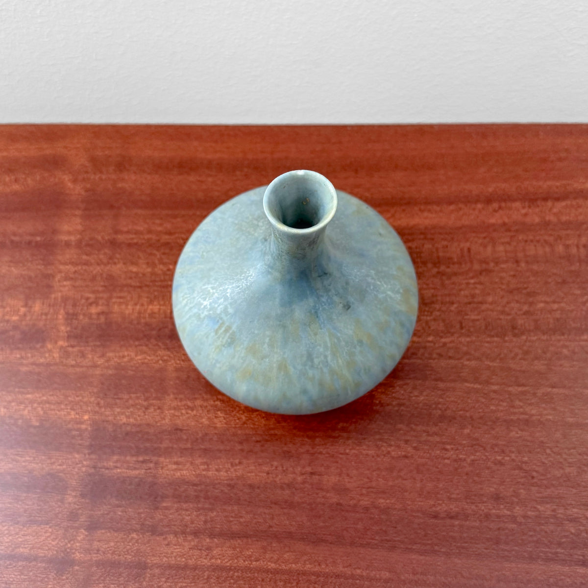 Carl-Harry Stålhane Rörstrand SYM Pale Blue Stoneware Vase in pale blue ceramic with a rounded form and narrow neck on a wooden surface
