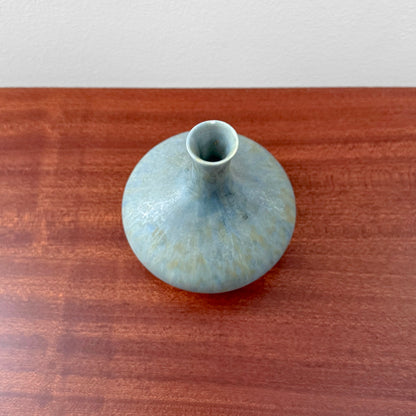 Carl-Harry Stålhane Rörstrand SYM Pale Blue Stoneware Vase in pale blue ceramic with a rounded form and narrow neck on a wooden surface