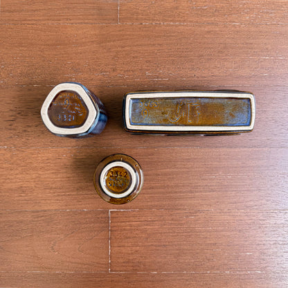 Einar Johansen Søholm Stoneware Decor Set, three ceramic decorative objects in blue brown glaze, shown from the underside on a wooden surface.