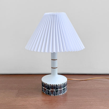 Ellen Malmer Royal Copenhagen Baca White Table Lamp (638/3480), ceramic table lamp with brown abstract motif and pleated white shade.