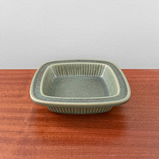 Gunnar Nylund Rörstrand Collier Green Decorative Dish in green glazed ceramic with a square shape and ridged sides on a wooden table