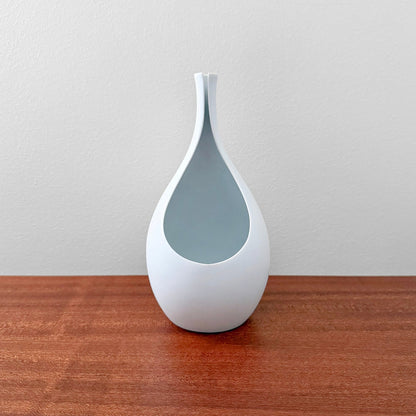 Gustavsberg Pungo White Vase (19 cm) made of ceramic with a smooth white Carrara glaze, designed by Stig Lindberg, displayed on a wooden surface against a neutral background.