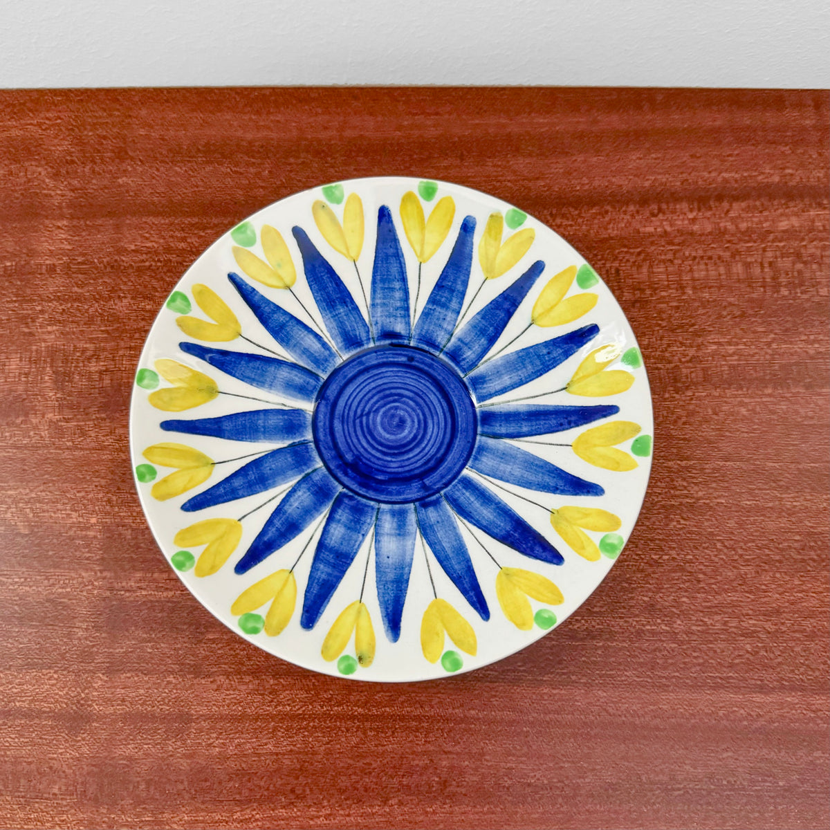 Hertha Bengtson Rörstrand Tea Cup with Saucer showcasing a vintage ceramic saucer with blue and yellow floral design, reflecting classic Nordic craftsmanship and style.