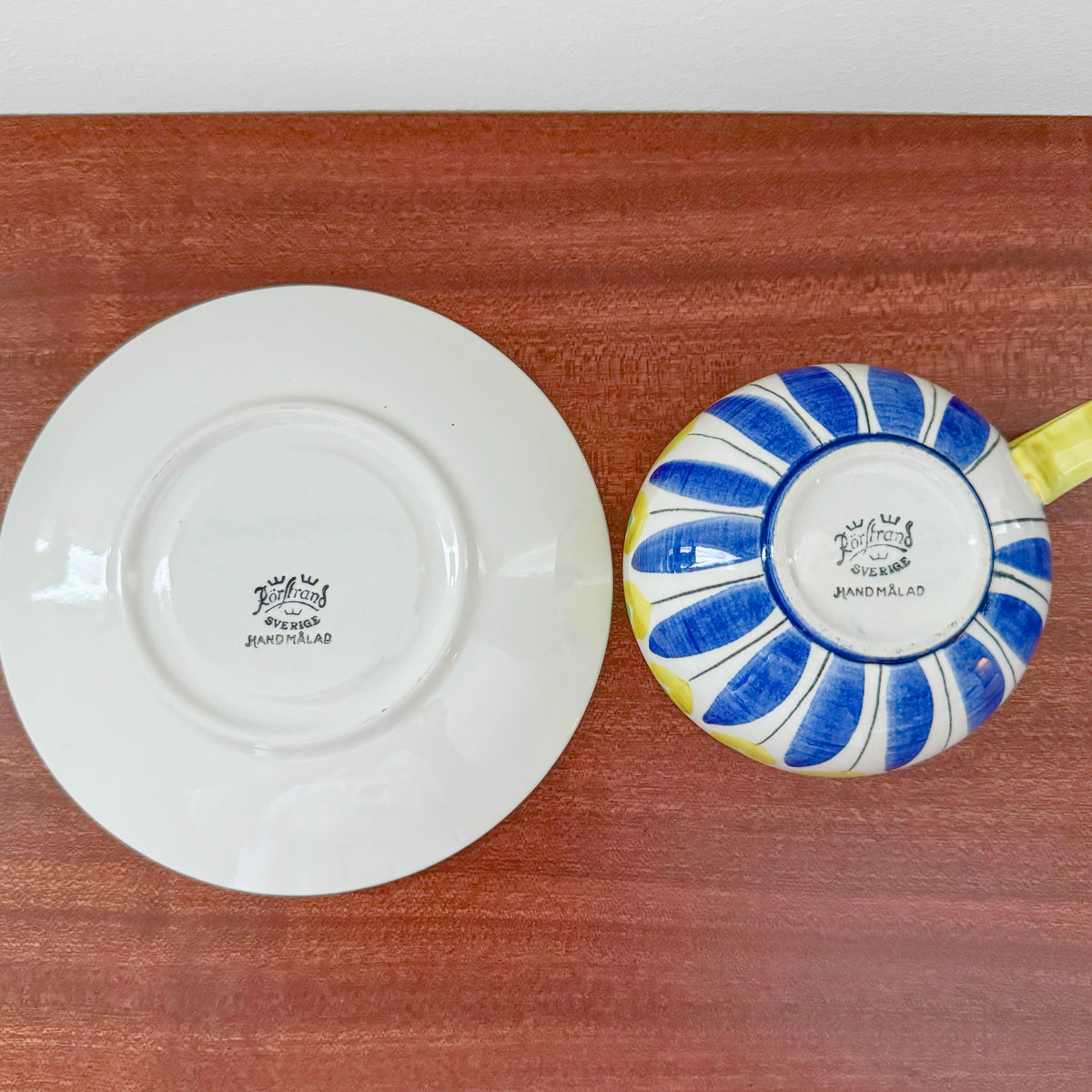 Hertha Bengtson Rörstrand Tea Cup with Saucer showing the underside with vintage maker’s marks, featuring blue and yellow hand-painted Scandinavian ceramic design.