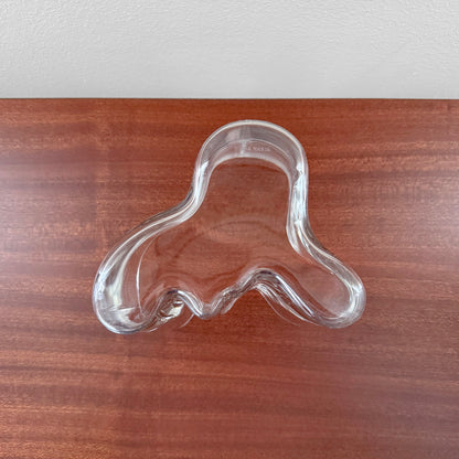 Iittala Aalto Savoy Clear Glass Vase (120 mm) featuring an organic, wavy shape made from clear glass, showcasing Scandinavian design by Alvar Aalto on a wooden surface.