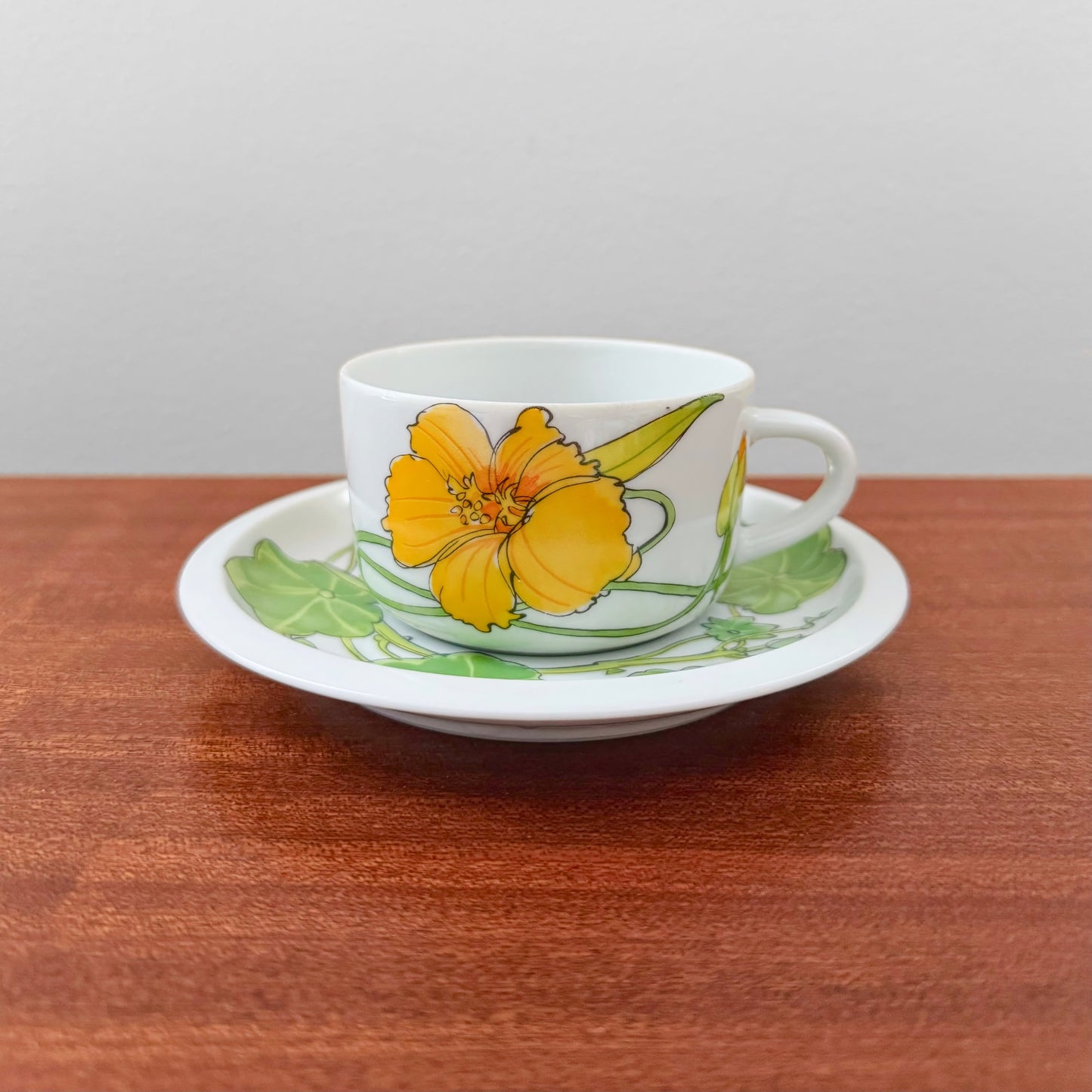 IKEA Krasse Herrgården Tea Cup with Saucer featuring a vibrant yellow floral design on white ceramic, showcasing vintage Scandinavian craftsmanship and style.