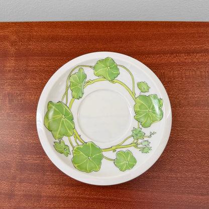 IKEA Krasse Herrgården Tea Cup with Saucer featuring a white ceramic saucer with a green leafy vine pattern, showcasing vintage Scandinavian design craftsmanship.
