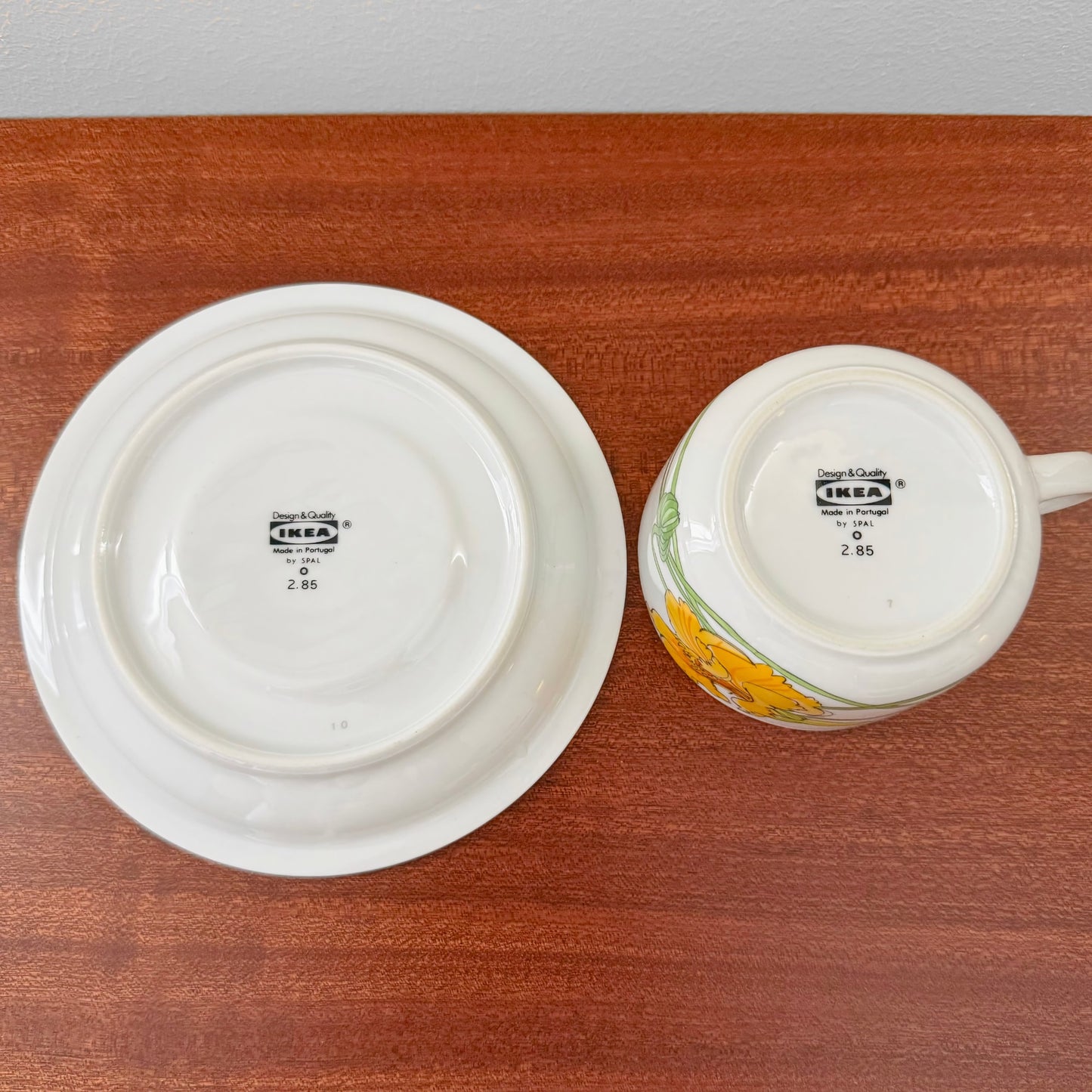 IKEA Krasse Herrgården Tea Cup with Saucer showing bottom stamps with vintage design marks, placed on a wooden surface, highlighting authentic Nordic craftsmanship.